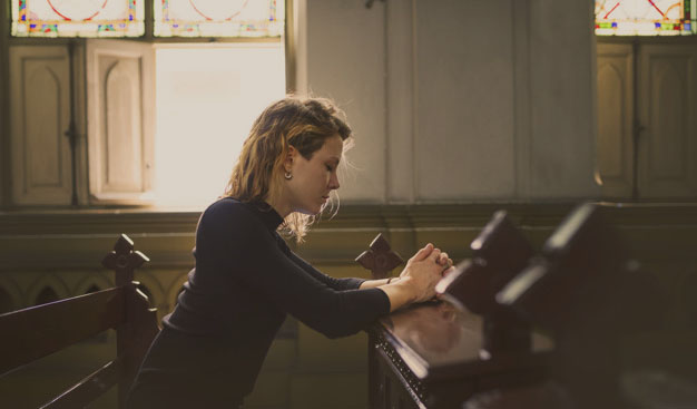 Woman praying in the church